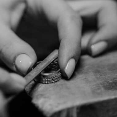 Black and white image showcasing the intricate process of crafting a ring by hand.