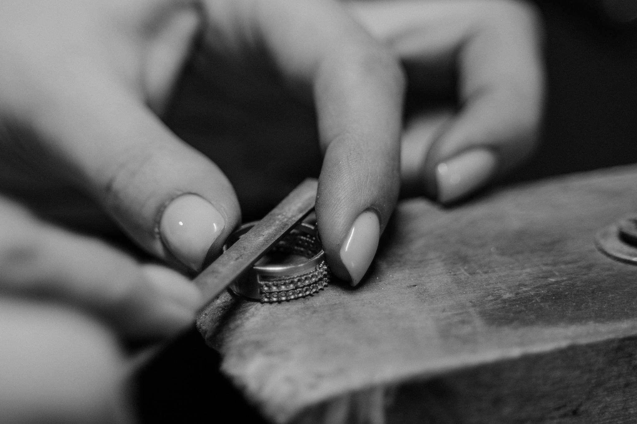 Black and white image showcasing the intricate process of crafting a ring by hand.