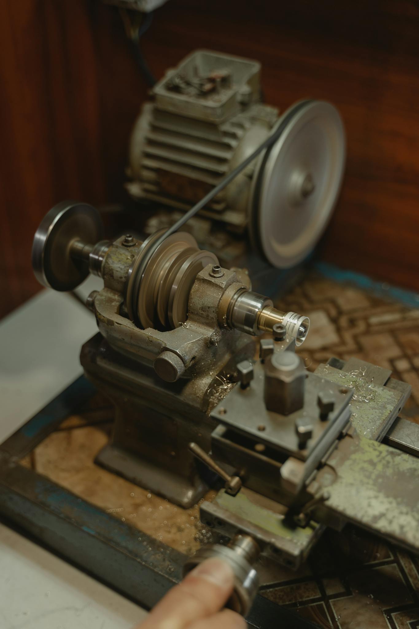 Detailed view of a metal lathe used for precision metalwork in an industrial workshop.